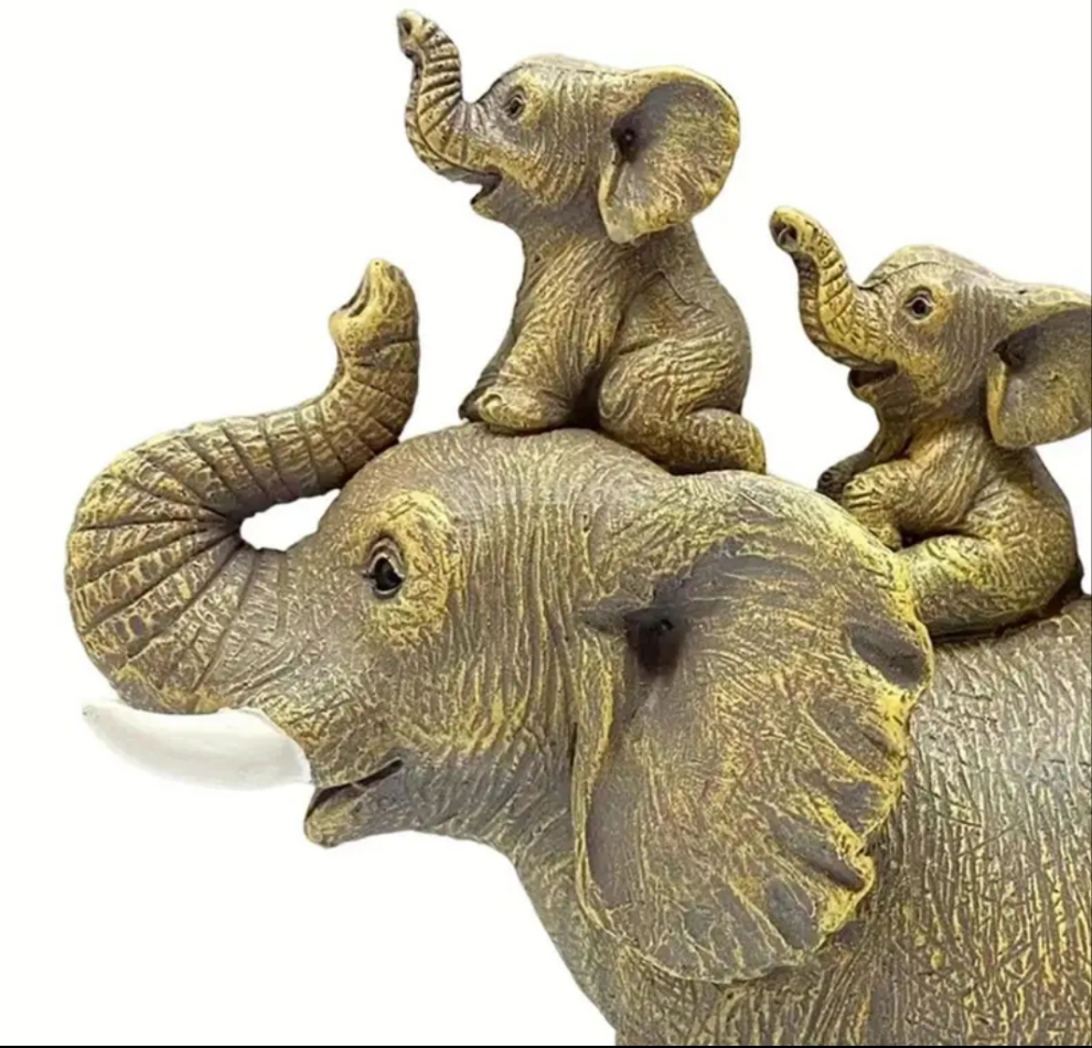 3 Baby Elephants Riding An Elephant Statue