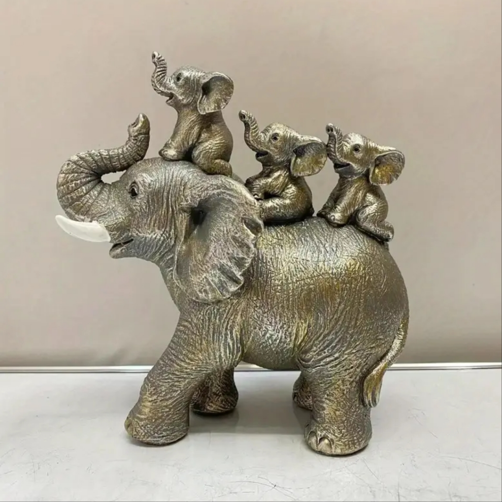 3 Baby Elephants Riding An Elephant Statue